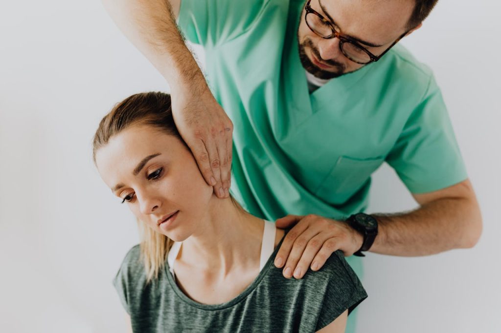 Professional massage therapist treating a female patient s injured neck 4506218